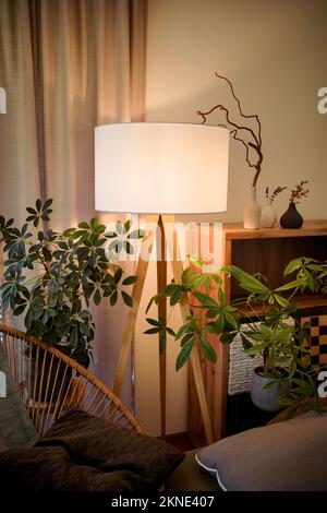 Lamp illuminating a living room with warm light Stock Photo