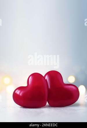 Two pink Valentine's day heart on pastel glitter grey background. Love concept, top view. Minimalism hipster style. Stock Photo