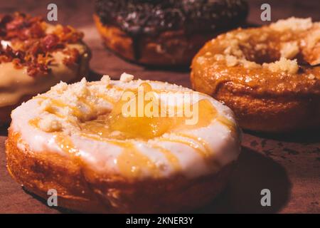 A close up of a fall-themed donut with white glaze and custard filling - concept of sweets Stock Photo