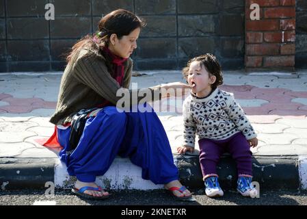 Mother and daughter eating ice cream outdoors. Stock Photo