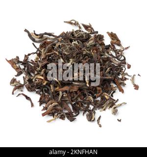 Heap of Phuguri Darjeeling Tea dried tea leaves close up isolated on white background Stock Photo
