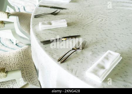 spoons forks knives on the table serving ,served table in restaurant. Stock Photo