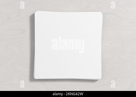 Stack of square sheets of paper on the white wooden table Stock Photo
