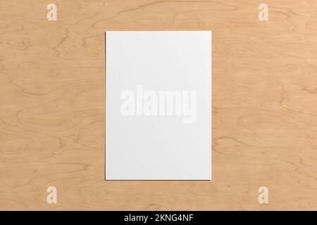 Blank sheet of paper mock up on the wooden table Stock Photo