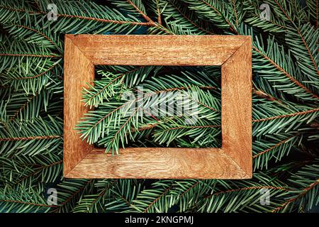 Wooden frame on Christmas tree branches. Texture background Stock Photo