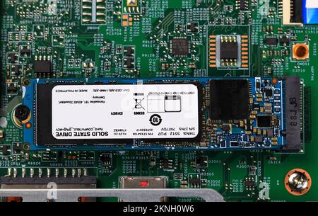 The blue SSD PCle NVMe M.2 on green motherboard background Stock Photo
