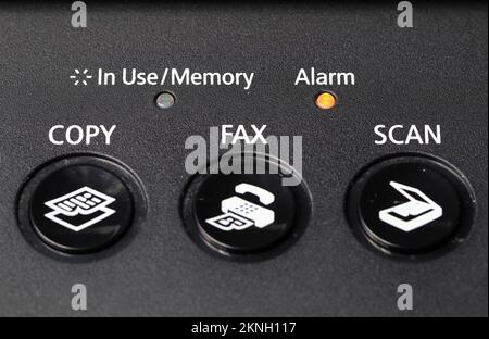 close up of Multifunction facsimile or fax keypad with yellow alarm light. Stock Photo