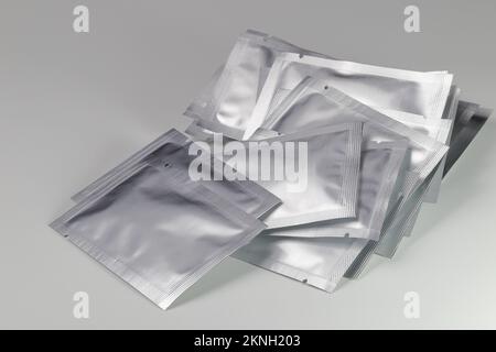 sheet foil package. silver plastic sachet mockup sample. Siver pouch, skin mask packaging design. Food zipper bag template, aluminum paper wrapper. Stock Photo