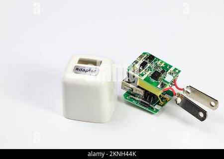 inside of usb charger adapter on white background, broken Charger gadgets isolated on a white background. The concept of charging technology to mobile Stock Photo
