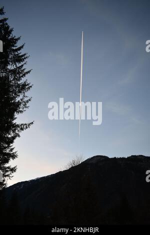 Winter sunset in the Austrian Alps as the plane is flying over Stock Photo