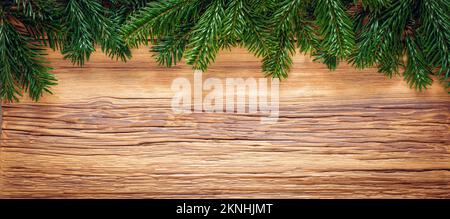 Christmas tree branches on wooden plank. Texture background Stock Photo