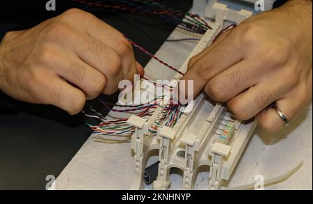 Hands at work in network cabling practice in an information technology classroom Stock Photo