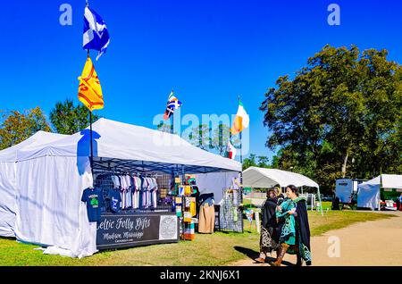 Two women in costume walk past a vendor’s booth during the annual Celtic Music Festival and Scottish Highland Games in Gulfport, Mississippi. Stock Photo