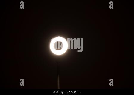 Round flexible LED lamp on the battery shines in the dark, light and technology, light bulb Stock Photo
