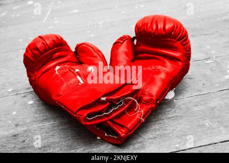 Beaten and battered boxing gloves in the ring of a training sports complex. Boxer still life Stock Photo