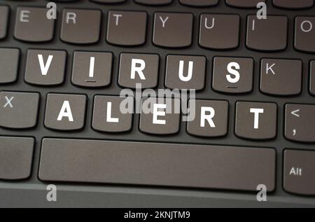Internet concept. On the black keyboard, the inscription is highlighted in white - Virus alert Stock Photo