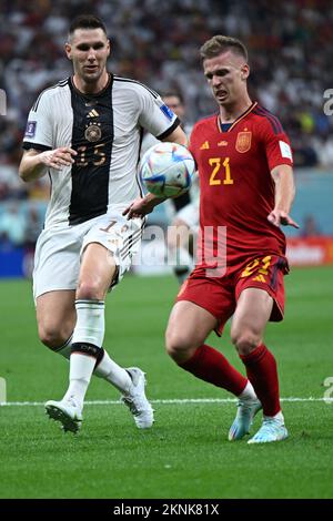 Al Chaur, Qatar. 27th Nov, 2022. Soccer, World Cup 2022 in Qatar, Spain - Germany, preliminary round, Group E, Matchday 2, at Al-Bait Stadium, Germany's Niklas Süle (l) and Spain's Dani Olmo fight for dan ball. Credit: Federico Gambarini/dpa/Alamy Live News Stock Photo