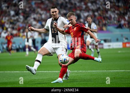 Al Chaur, Qatar. 27th Nov, 2022. Soccer, World Cup 2022 in Qatar, Spain - Germany, preliminary round, Group E, Matchday 2, at Al-Bait Stadium, Germany's Niklas Süle (l) and Spain's Dani Olmo fight for the ball. Credit: Federico Gambarini/dpa/Alamy Live News Stock Photo