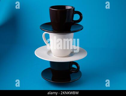 photo coffee cups on saucers on a blue background standing upright Stock Photo