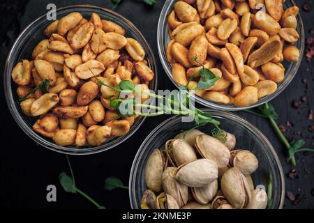 Salted nuts, pistachios and peanuts, for beer, on a dark background Stock Photo
