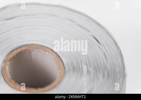 Rolled up roll of recycled white paper. Macro. Rotation Stock Photo