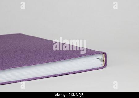 Close up of top of purple cover diary isolated on white background Stock Photo