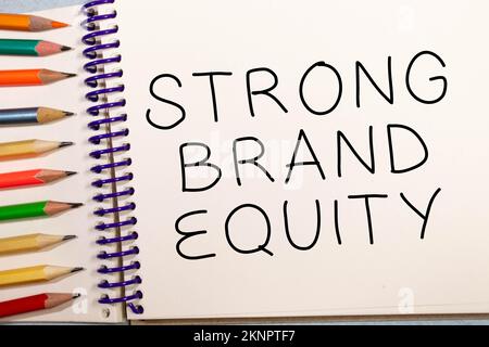 Strong brand equity symbol. Concept words Strong brand equity on wooden blocks on a beautiful black table black background. Business, finacial and str Stock Photo