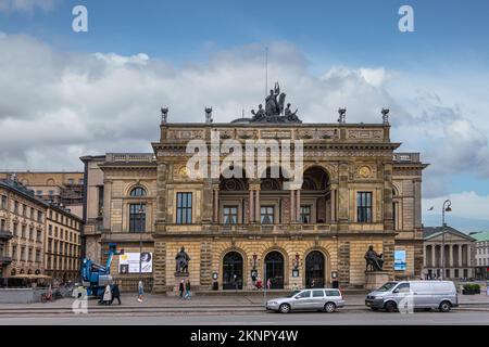 Copenhagen, Denmark - July 23, 2022: Artfiully decorated with paintings, murals, statues, and arches, yellow stone front facade of The Royal Theatre u Stock Photo