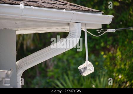 Motion sensor with light detector mounted on exterior wall of private house as part of security system Stock Photo