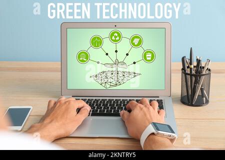 Businessman using laptop in office. Green technology concept Stock Photo