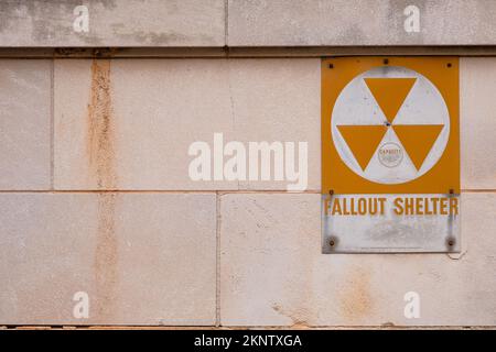 Rock Hillh, South Carolina, USA - November 20, 2022: Old and worn fallout shelter sign on foundation of public building. Stock Photo