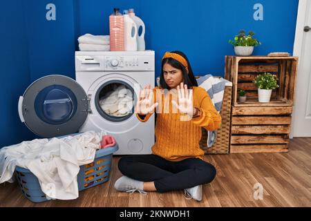 Doing the laundry in the 1960s. A lady is using a washboard to