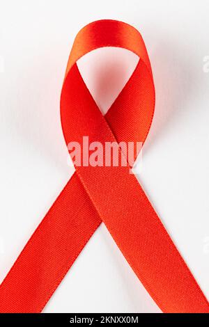 Vertical composition of red ribbon for hiv or aids awareness, on white background Stock Photo