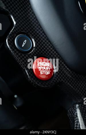 A vertical shot of the red engine button of a Ferrari 488 GTB Stock Photo