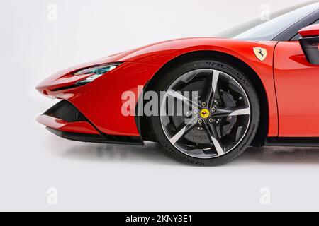 The front end of a red Ferrari SF90 Stradale in a studio, on white background Stock Photo