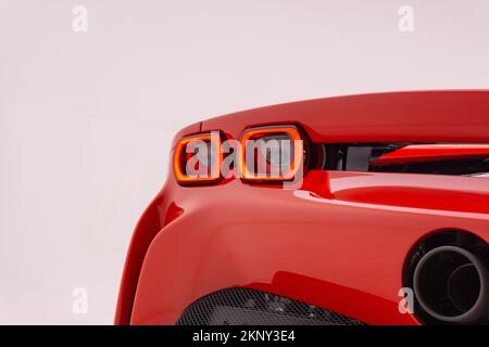 The taillights of a red Ferrari SF90 Stradale in a studio, on white background Stock Photo