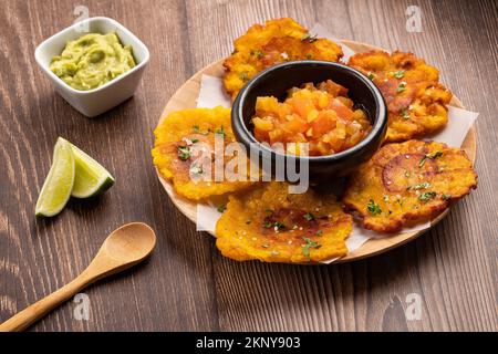 Patacon or toston, fried and flattened pieces of green plantain Stock Photo