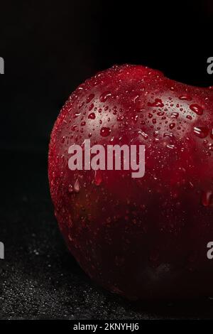 red apple with water drops on black background Stock Photo