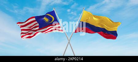 two crossed flags Colombia and Malaysia waving in wind at cloudy sky. Concept of relationship, dialog, travelling between two countries. 3d illustrati Stock Photo