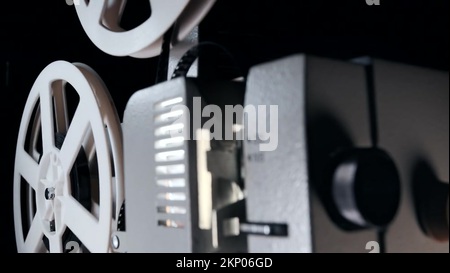 White reels with film rotating. Analog player. Retro old-fashioned 8mm  movie projector playing in dark at home theater. Vintage objects, cinema, cinematograph  concept Stock Video Footage - Alamy