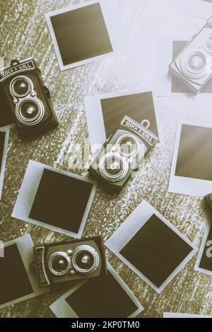 Creative film style photo on a selection of old camera technology with filtered retro composition. Antique photographic scene Stock Photo