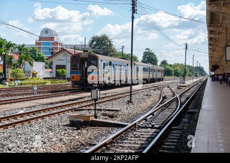 Train on the railway station at local station to drive out station in the dayะime. Stock Photo