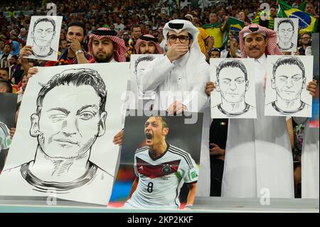 Football fans in the stands hold portraits of German football player Mesut Ozil during the Qatar 2022 World Cup Group E football match between Spain and Germany at the Al-Bayt Stadium in Al Khor, north of Doha on November 27, 2022. Photo by Laurent Zabulon/ABACAPRESS.COM Stock Photo