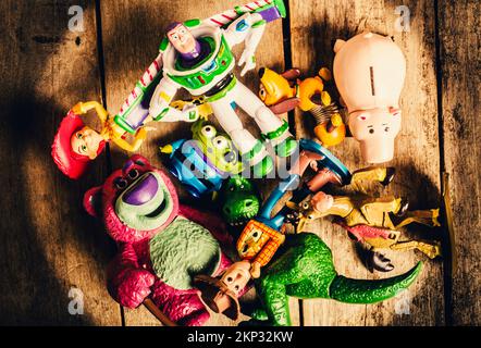 Rustic wooden still life scene on a heap of preschool play toys from movies past. Childhood collectibles Stock Photo
