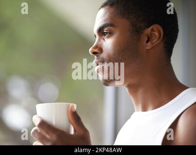 Relaxing before my busy day. A handsome male holding a hot beverage. Stock Photo