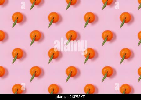 Mandarin oranges pattern on pink background. Creative pattern, fruit background. Stock Photo