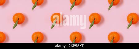 Banner with mandarin oranges pattern on pink background. Creative pattern Stock Photo