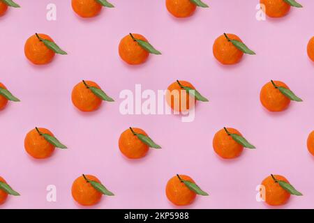 Mandarin oranges pattern on pink background. Creative pattern, fruit background. Stock Photo
