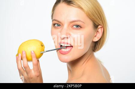 Battery concept. Nutritious drink fill with energy. Lemon with hobnail natural battery. Recharge your body vitamins. Girl drink fresh juice whole Stock Photo