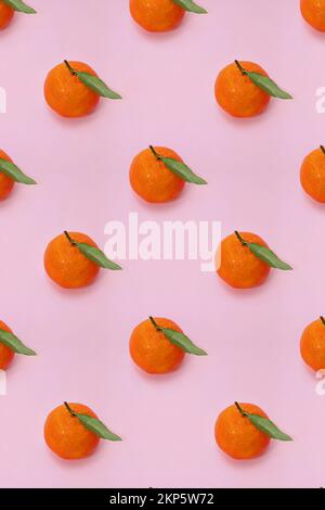 Mandarin oranges pattern on pink background. Creative pattern, fruit background. Stock Photo